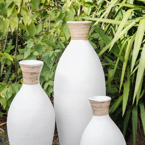 White terracotta slimline vases with rattan detail.