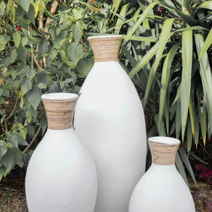 White terracotta slimline vases with rattan detail.